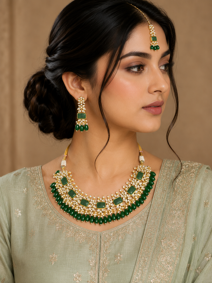 Emerald green kundan choker with matching earrings and maang tikka