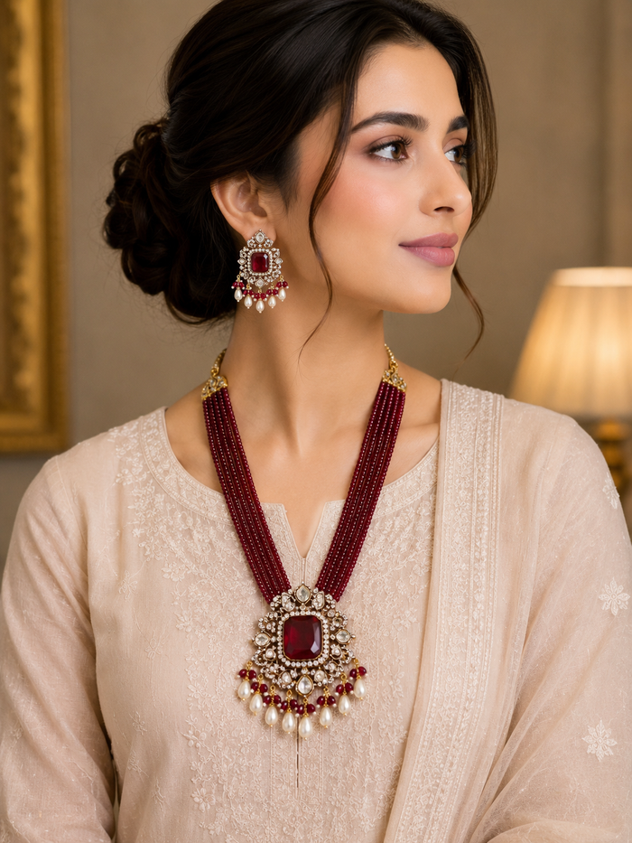 Maroon beaded rani haar with gold kundan pendant and matching earrings